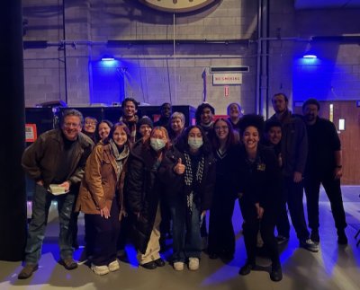 A group of folks posing for a backstage group photo